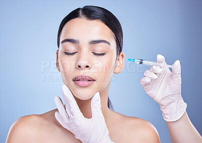 Buy stock photo A gorgeous mixed race woman getting botox filler in her face. Hispanic model getting cosmetic surgery against a blue copyspace background