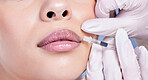 Closeup of a  gorgeous mixed race woman getting botox filler in her face. Hispanic model getting cosmetic surgery getting lip fillers