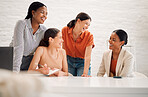 Group of happy diverse businesswomen having a meeting together in a boardroom at work. Cheerful businesspeople talking and planning in a workshop in an office
