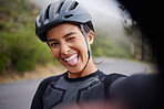 Portrait of a happy athletic young woman taking a selfie during a break from cycling outside . Sporty fit mixed race female wearing a helmet and taking a break to take photo of herself. There's always time to be a bit quirky