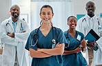 Group of happy diverse doctors standing with their arms crossed while working at a hospital. Expert medical professionals smiling at work together at a clinic