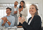 Group of businesspeople in a meeting together at work. Mature caucasian businesswoman clapping with her colleagues while in a workshop. Business professionals clapping in support in an office