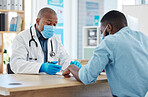 African american doctor talking to a patient in a consult. Doctor and patient talking about their chart in a checkup. Doctor and patient talking covid test results in the hospital