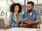 Young happy mixed race couple going through documents and using a digital tablet and laptop at a table together at home. Hispanic husband and wife smiling while planning and paying bills. Boyfriend and girlfriend working on their budget