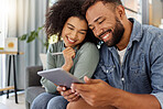 Happy young mixed race couple smiling while using a digital tablet together at home. Cheerful hispanic boyfriend and girlfriend bonding and using social media on a digital tablet in the lounge at home