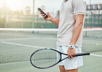 Unknown mixed race tennis player using cellphone to text during break in game on court. Hispanic fit athlete browsing internet and networking on phone after match. Active healthy man in sports club