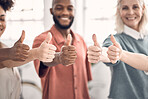 Group of businesspeople showing a thumbs up together in an office at work. Content business professionals making a hand gesture showing support and agreement. Colleagues showing that they are pleased and happy