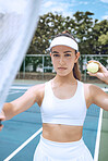 Confident young female tennis player holding a tennis racket and ball. Hispanic woman ready for her tennis match at the club. Sportswoman ready for tennis practice