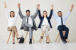 Group of diverse businesspeople celebrating success after interview. Team of applicants together, holding hands with arms raised. Candidates in line for job opening, vacancy and office opportunity