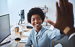 Happy african american call centre telemarketing agent giving colleague high five and cheering with joy while working in an office. Excited and ambitious female consultant celebrating successful sales targets and winning victory