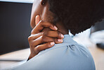 Closeup of one stressed african american businesswoman suffering with neck pain in an office. Entrepreneur rubbing muscles and body while feeling tense strain, discomfort and hurt from bad sitting posture and long working hours at desk