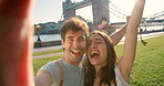 Cheerful young couple taking a selfie in front of Westminster bridge